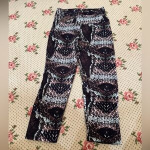 Bandier x Candida Maria activewear leggings with a multicolor reptile print